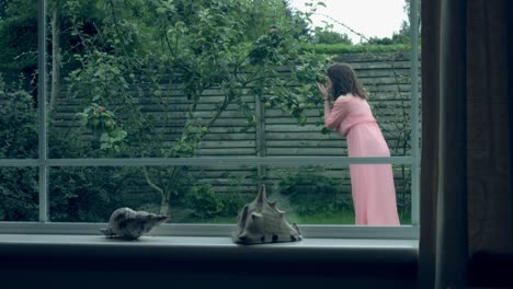 4k-Shot-of-a-Woman-posing-with-an-Apple-Tree-in-the-Garden