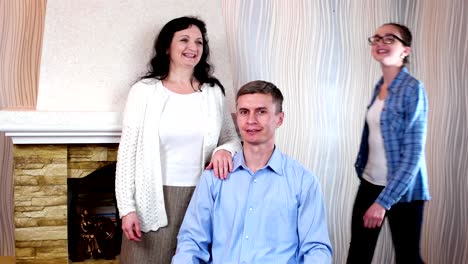 smiling-family-gathering-together-to-pose-for-family-portrait,-happy-family-members-near-fireplace