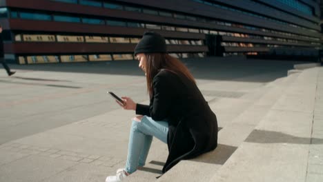 Portrait-of-young-African-American-woman-using-phone,-outdoors.