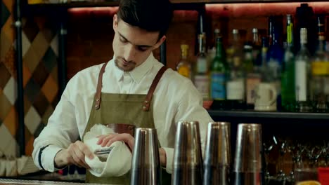 Barman-rub-metal-shakes-with-napkin-at-work-place