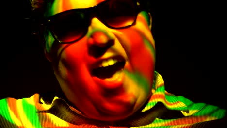 Portrait-of-a-fat-man-in-a-multicolored-light-beam.