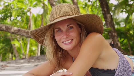 Portriat-of-woman-laying-on-tropical-beach.