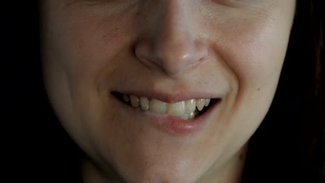 Close-up-of-young-woman-licking-lips-and-smiling.-Close-up.-Brown-hair