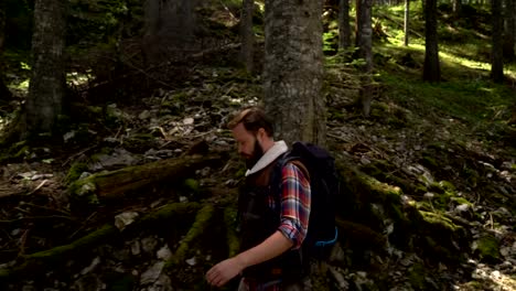 Traveler-with-a-backpack-walks-through-the-forest