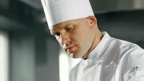 Close-up-of-a-Famous-Chef-Concentrated-on-Cooking-Perfect-Dish.