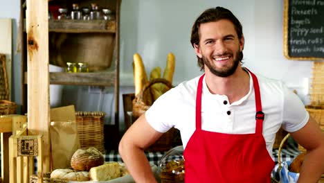 Smiling-male-staff-standing-with-hand-on-hip