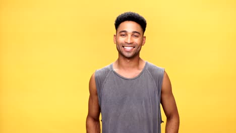 Young-happy-african-man-over-yellow-background.