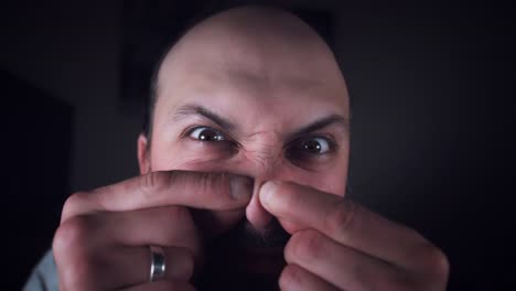 4K-Portrait-Man-Looking-in-Mirror-and-Checking-Acne