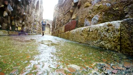 4K-action-footage-of-a-traveler-with-backpack-walking-around-the-Qutb-Minar-mosque-in-Delhi