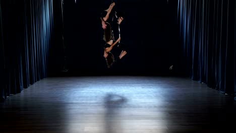 Flexible-girls-makes-a-gymnastic-elements-on-the-aerial-hoop