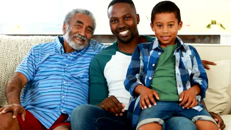 Smiling-multi-generation-family-sitting-together-on-sofa