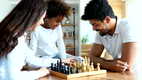Happy-family-playing-chess-together-at-home