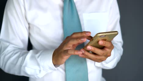 CU---Businessman-playing-his-phone