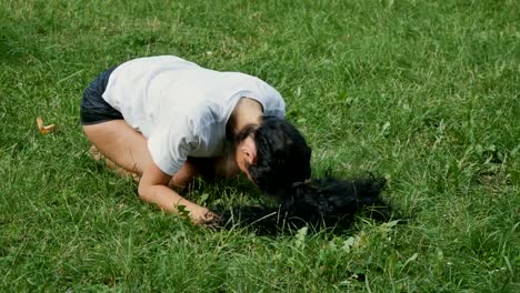 Young-woman-makes-yoga-exercise-on-grass