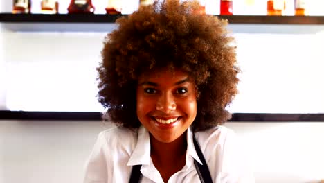 Portrait-of-confident-waitress-standing-at-counter