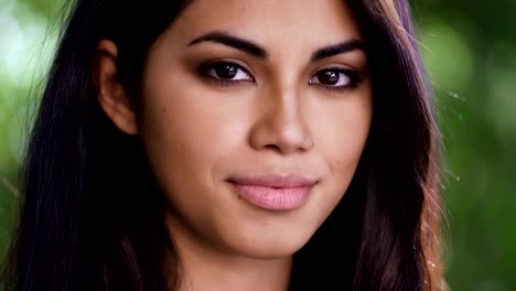 Close-Up-on-Beautiful-Asian-Woman-Turning-Toward-Camera-And-Smiling-Softly