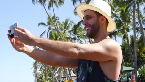 Young-Man-taking-a-selfie-in-Forte-Beach,-Brazil