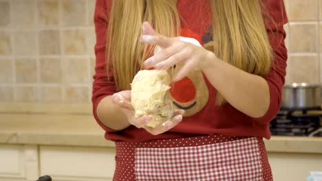 Woman-kneads-dough-for-cookies