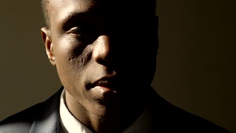 Depressed-and-sad-young-black-business-man-in-shadow