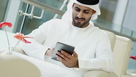 Portrait-Arabic-male-business-consultant-tablet-downtown-hotel