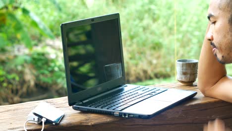 Business-asian-man-using-laptop-at-his-home