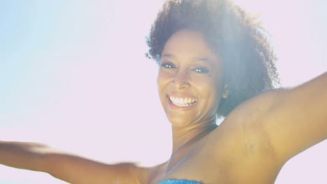 Portrait-of-young-ethnic-woman-on-beach-holiday