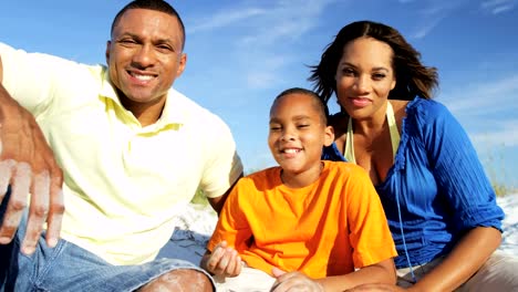 Portrait-of-ethnic-parents-and-son-on-beach