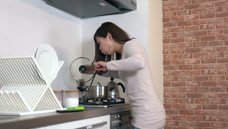 Food-Burning-On-Stove-And-Woman-Running-In-Home-Kitchen