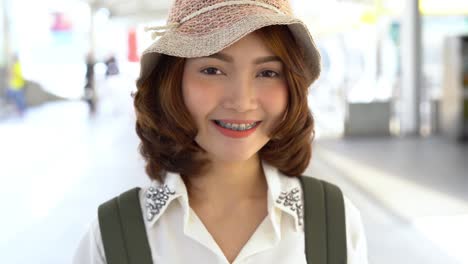 Attractive-young-smiling-Asian-woman-outdoors-portrait-in-the-city-real-people-series.-Outdoors-lifestyle-fashion-portrait-of-happy-smiling-Asian-girl.-Summer-outdoor-happiness-portrait-concept.