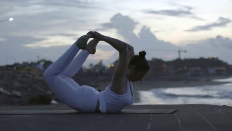 Woman-Doing-Bow-Pose-on-Beach