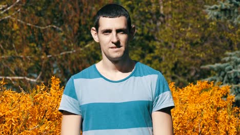 Portrait-of-a-Young-Cute-European-Guy-Looking-in-the-Lens-and-Smiling-in-Nature-in-the-Summer