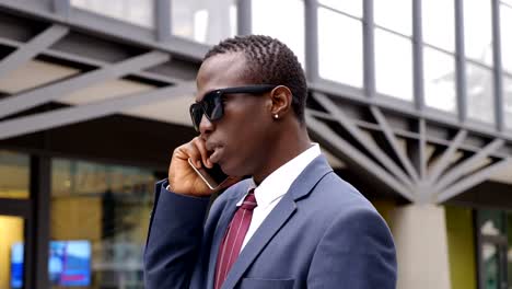 confident-young-african-american-businessman-talking-by-phone