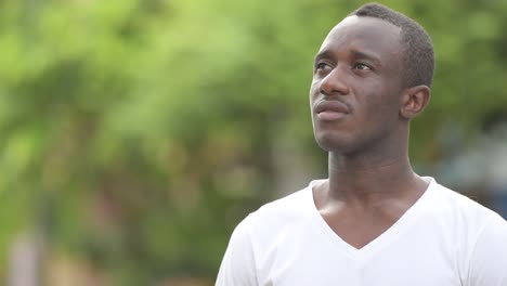 Young-African-man-thinking-in-the-streets-outdoors