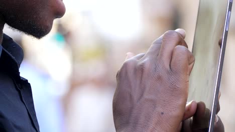 communication,devices,youth.-Black-man's-hands-typing-on-smartphone--outdoor