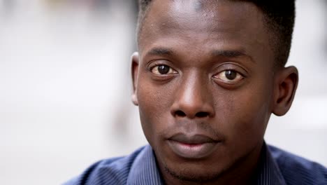 close-up-portrait-of-Relaxed-attractive-young-black-african-man-staring-at-camera--outdoor