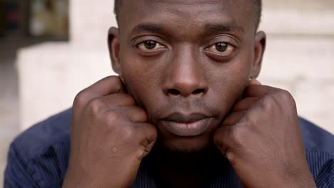 sad-desperate-young-black-man-raising-his-head-and-staring-at-camera