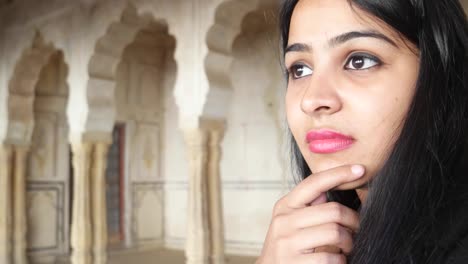 Closeup-of-woman-with-black-hair-working-on-a-touch-screen-tablet-pad-handheld-business-network-online-wireless-connection-thinking-idea-eureka-calculate-at-an-old-building-complex-ancient