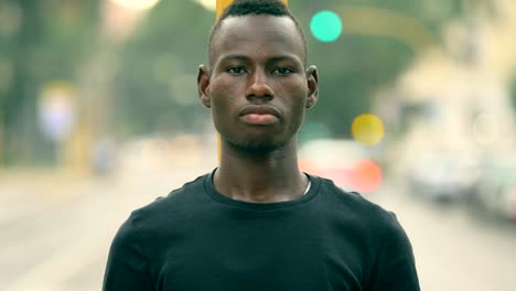 Proud-handsome-young-black-african-in-the-street,-looking-at-camera