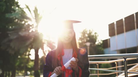 Graduated-student-raising-her-diploma-up