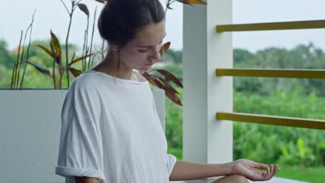 Woman-Performing-Neck-Circles-on-Balcony