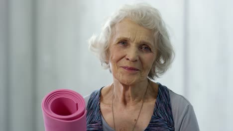 Senior-Woman-with-Yoga-Mat-Posing