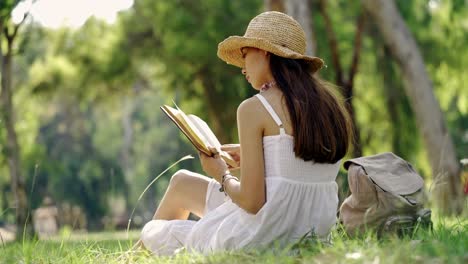 Young-woman-reading-a-book--outdoors