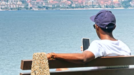 Black-male-traveler-using-smart-phone