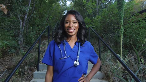 Beautiful-African-American-woman-in-scrubs-smiling-at-the-camera