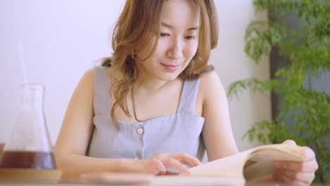 Young-Chinese-Student-with-books-In-the-library