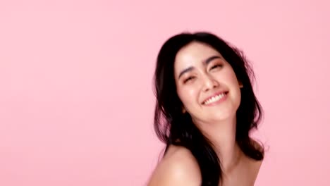 Attractive-woman-with-happy-emotion-at-pink-background.-People-emotion-concept.-4k-resolution.