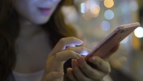 Young-Asian-Woman-Using-Smart-Phone-in-the-City-at-night