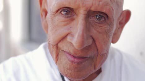 Close-up-portrait-of-an-old-wise-hispanic-man-staring-into-the-camera