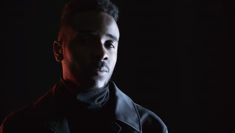 Portrait-Shot-of-Black-Man-in-Dark-Studio