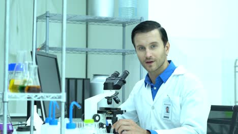 Portraits-of-scientist-male-is-looking-through-microscope-and-working-in-modern-laboratory-or-medical-center.-Concept-of-science,-testing-development-and-lab-industry.